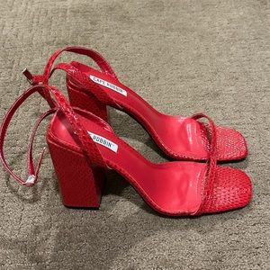 - Snake print red heels. Never worn
